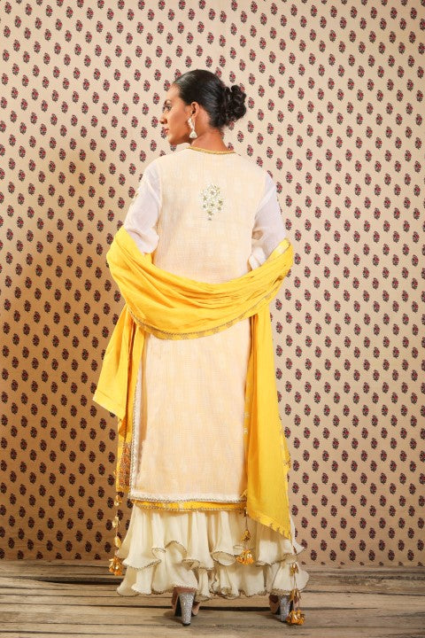 IVORY AND PITAMBARI YELLOW SIGNATURE LAYERED KURTA PAIRED WITH DOUBLE LAYERED SHARARA AND COTTON DUPATTA.