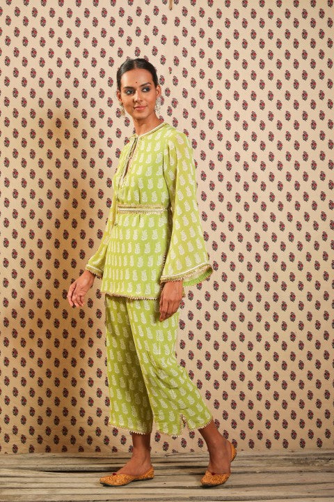 LIME GREEN GEORGETTE KURTA PAIRED WITH STRAIGHT PANTS AND BELT.