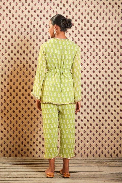 LIME GREEN GEORGETTE KURTA PAIRED WITH STRAIGHT PANTS AND BELT.