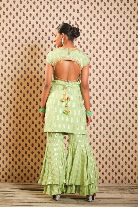 PISTA GREEN ANGRAKHA PAIRED WITH DOUBLE LAYERED SHARARA AND HANDWOVEN KOTA DORIA DUPATTA.