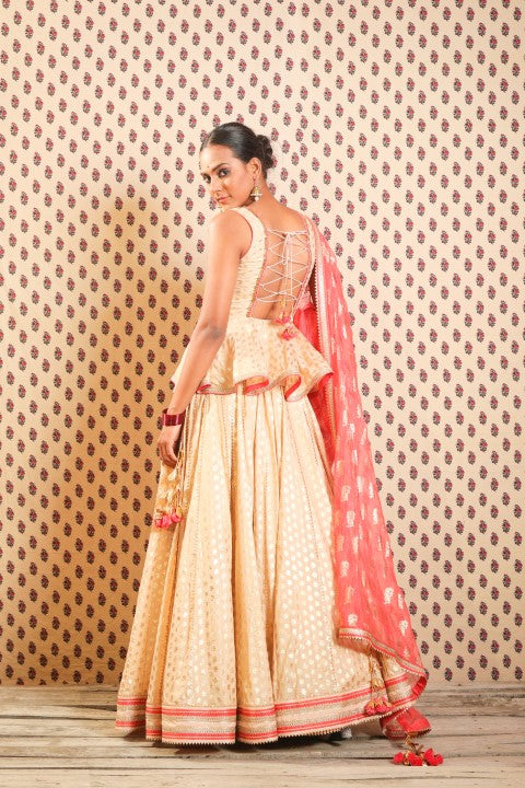 LIGHT CAMEL PEPLUM BLOUSE PAIRED WITH LOTUS PRINT LEHENGA DUPATTA.