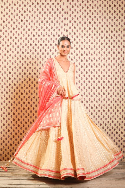 LIGHT CAMEL PEPLUM BLOUSE PAIRED WITH LOTUS PRINT LEHENGA DUPATTA.