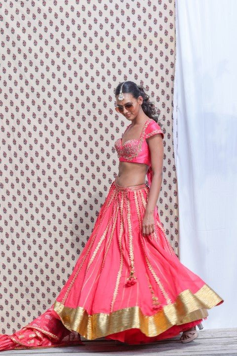 CORAL RED COTTON SILK BLOUSE PAIRED WITH ORGANDI LEHENGA AND KOTA DORIA DUPATTA.