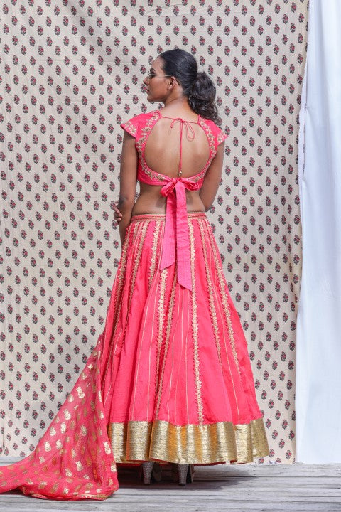 CORAL RED COTTON SILK BLOUSE PAIRED WITH ORGANDI LEHENGA AND KOTA DORIA DUPATTA.