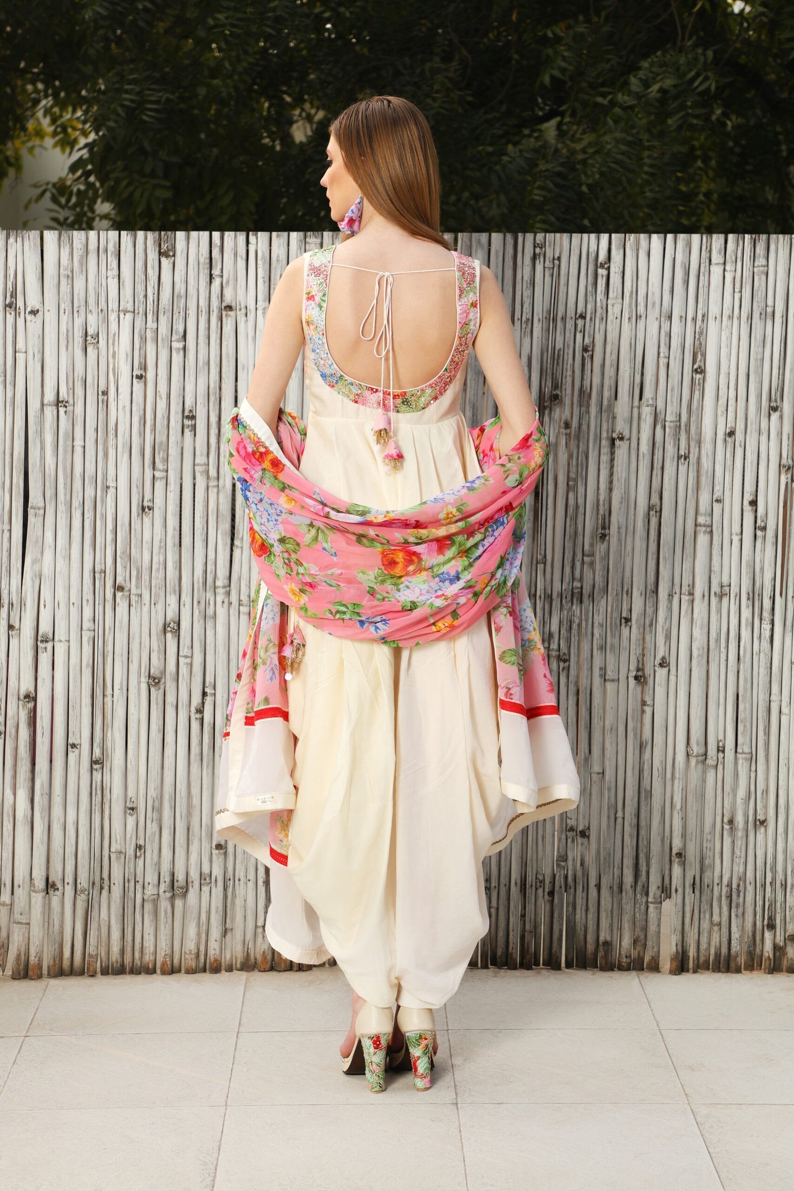 Ivory cotton silk peplum top teamed with cowl dhoti and a mithai pink vintage rose dupatta.