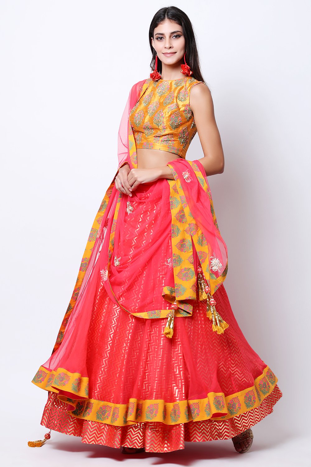 Ochre hand-printed blouse with printed organza top layer skirt with ochre border and dupatta.