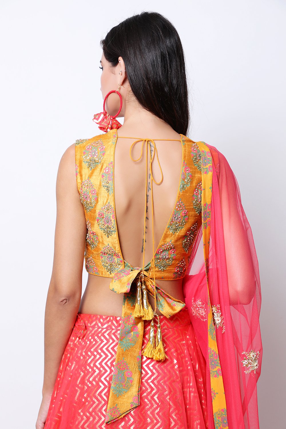 Ochre hand-printed blouse with printed organza top layer skirt with ochre border and dupatta.