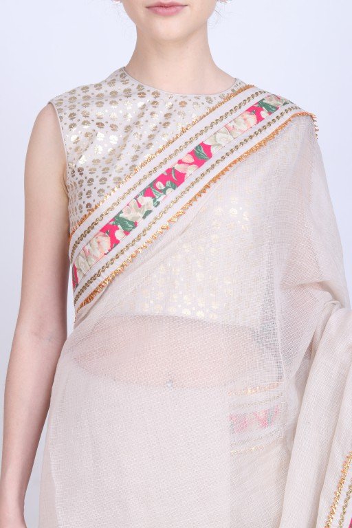 Ghee kota doria saree paired with a gold foil printed blouse .