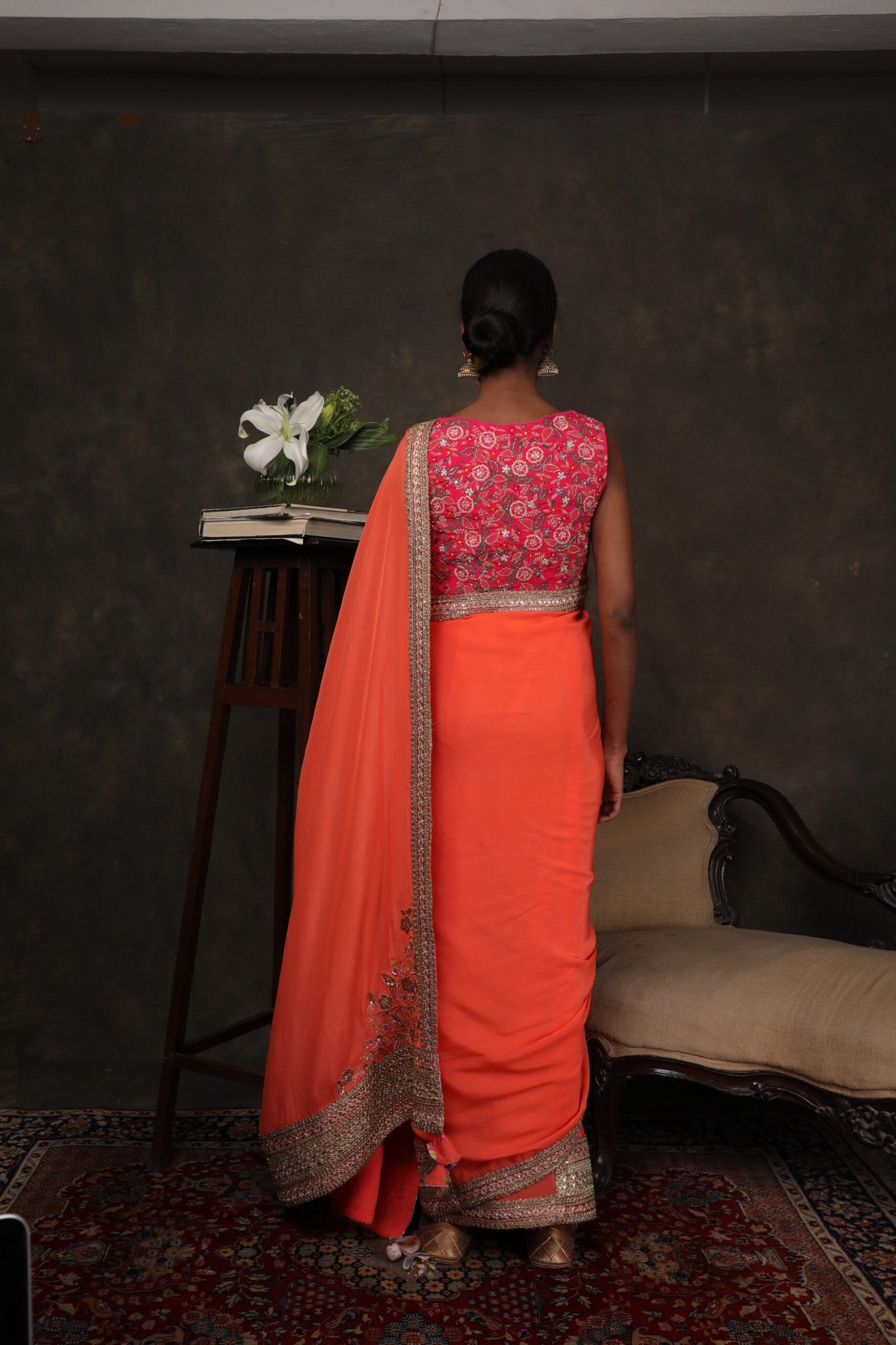Coral crepe saree with a thread work rani pink blouse.
